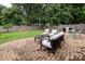 Brick patio area with outdoor seating overlooking the well-maintained backyard at 5741 Bentgrass Run Dr, Charlotte, NC 28269