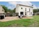 View of the backyard with patio, well-maintained lawn, and white siding house at 5741 Bentgrass Run Dr, Charlotte, NC 28269