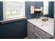 A well-lit bathroom with a white vanity, a large mirror and a window providing natural light at 5741 Bentgrass Run Dr, Charlotte, NC 28269