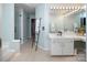 Bathroom featuring walk-in shower, dual vanity, and modern ladder towel rack providing a spa-like retreat at 5741 Bentgrass Run Dr, Charlotte, NC 28269