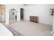 Spacious bedroom with a large mirror, carpet, and ample natural light, creating a serene atmosphere at 5741 Bentgrass Run Dr, Charlotte, NC 28269
