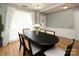 Stylish dining room with a chandelier, table, and views to the entryway at 5741 Bentgrass Run Dr, Charlotte, NC 28269