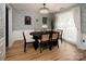 Elegant dining room with modern chandelier, stylish decor, and large window at 5741 Bentgrass Run Dr, Charlotte, NC 28269