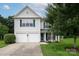 Charming two-story home with a well-maintained lawn and a two-car garage at 5741 Bentgrass Run Dr, Charlotte, NC 28269