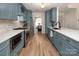 Modern kitchen with stainless steel appliances, shaker cabinets, and island sink at 5741 Bentgrass Run Dr, Charlotte, NC 28269