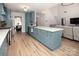 Open-concept kitchen with shaker cabinets, stainless appliances, and a center island with sink at 5741 Bentgrass Run Dr, Charlotte, NC 28269