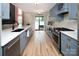 Modern kitchen with stainless steel appliances, shaker cabinets, and backyard access at 5741 Bentgrass Run Dr, Charlotte, NC 28269