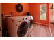 Bright laundry room featuring a washer, dryer, window, and stylish accents, offering functionality and charm at 5741 Bentgrass Run Dr, Charlotte, NC 28269
