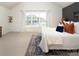 Bedroom with large window, textured rug, and tasteful decor offers a bright, peaceful retreat at 5741 Bentgrass Run Dr, Charlotte, NC 28269