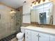 Modern bathroom featuring a glass-enclosed shower and vanity with tile accents at 5809 Sharon Rd # G, Charlotte, NC 28210