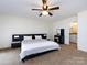 Bedroom with large bed, carpet, ceiling fan, and furniture at 5809 Sharon Rd # G, Charlotte, NC 28210
