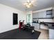 Well-equipped home gym with exercise equipment, rubber flooring, and plenty of storage at 5809 Sharon Rd # G, Charlotte, NC 28210