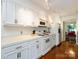 Bright kitchen with white cabinetry, modern appliances, and hardwood floors for a classic look at 5809 Sharon Rd # G, Charlotte, NC 28210