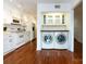 Convenient laundry area with modern appliances and built-in cabinets adjacent to the kitchen at 5809 Sharon Rd # G, Charlotte, NC 28210
