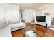 Open living area featuring hardwood floors, a modern sofa, a glass coffee table, and stylish decor at 5809 Sharon Rd # G, Charlotte, NC 28210