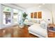 Cozy living room with a comfortable white sofa, glass coffee table, and access to an outdoor patio at 5809 Sharon Rd # G, Charlotte, NC 28210