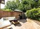 Inviting outdoor patio with comfortable seating, brick accents, and a grill at 5809 Sharon Rd # G, Charlotte, NC 28210