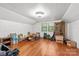 Finished attic with hardwood floors, white ceilings and walls, storage, and natural light from a window at 606 1St W St, Conover, NC 28613