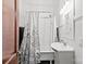Traditional bathroom with a pedestal sink, tub and shower featuring a floral shower curtain and black and white accent tiles at 606 1St W St, Conover, NC 28613