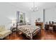 This bedroom features hardwood floors, a decorative fireplace, a large bed, neutral paint and updated lighting at 606 1St W St, Conover, NC 28613