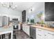 Well-lit kitchen boasts white cabinets, butcher block counters, stainless appliances, and sleek black accents at 606 1St W St, Conover, NC 28613