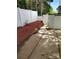 Backyard features a concrete patio, and red mulch along a white wooden fence at 7107 Stonington Ln, Charlotte, NC 28227