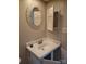Close-up of a bathroom vanity with a round mirror and white sink at 7107 Stonington Ln, Charlotte, NC 28227