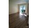 A sunlit living room with sliding glass doors and new wood-look floors at 7107 Stonington Ln, Charlotte, NC 28227