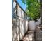 View of the side yard, showing a white fence and a path to a gated entrance and retaining wall at 7107 Stonington Ln, Charlotte, NC 28227