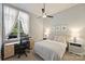 Bedroom featuring a work space, neutral colors, a ceiling fan, and a window with curtains at 718 W Trade St # 105, Charlotte, NC 28202