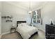 Cozy bedroom featuring a large window with curtains, and a neutral color scheme at 718 W Trade St # 105, Charlotte, NC 28202