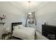 Cozy bedroom featuring a large window with curtains, and a neutral color scheme at 718 W Trade St # 105, Charlotte, NC 28202