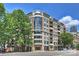 Modern condominium building showcasing large windows, balconies, and a street-level Subway restaurant at 718 W Trade St # 105, Charlotte, NC 28202