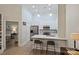 Modern kitchen featuring stainless steel appliances, counter seating, and an adjacent bedroom at 718 W Trade St # 105, Charlotte, NC 28202