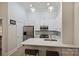 Bright kitchen features white cabinets, stainless steel appliances, and pendant lighting at 718 W Trade St # 105, Charlotte, NC 28202