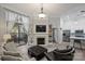 Light-filled living room boasts a fireplace, built-in bookshelves, and a sliding door to the balcony at 718 W Trade St # 105, Charlotte, NC 28202