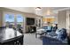 Spacious living area boasts large windows, a kitchen bar, and stylish decor at 718 W Trade St # 105, Charlotte, NC 28202