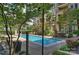 Community pool with lounge chairs provides a relaxing oasis in a landscaped setting at 718 W Trade St # 105, Charlotte, NC 28202