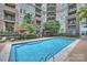Inviting community pool features lounge chairs and sun umbrellas for a perfect day of relaxation at 718 W Trade St # 105, Charlotte, NC 28202