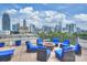 Relax on the rooftop terrace with city skyline views and a fire pit surrounded by comfortable seating at 718 W Trade St # 105, Charlotte, NC 28202