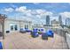 Enjoy city views from the rooftop terrace, featuring stylish seating and a cozy fire pit at 718 W Trade St # 105, Charlotte, NC 28202