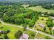 Stunning aerial view of the property nestled amidst mature trees and lush green landscape at 7725 Whitmire Ln, Mint Hill, NC 28227