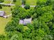 Aerial view of a home surrounded by mature trees and a lush green landscape at 7725 Whitmire Ln, Mint Hill, NC 28227