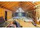 Unfinished attic space with exposed beams and a partially framed window at 7725 Whitmire Ln, Mint Hill, NC 28227