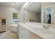 Bright bathroom with double sink vanity, soaking tub, and natural light from a window at 7725 Whitmire Ln, Mint Hill, NC 28227