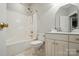Clean bathroom with a shower-tub combo, toilet, vanity, and mirrored medicine cabinet at 7725 Whitmire Ln, Mint Hill, NC 28227
