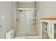 Bathroom featuring toilet, glass-enclosed shower, and built-in shelves for storage at 7725 Whitmire Ln, Mint Hill, NC 28227
