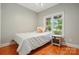 Cozy bedroom with hardwood floors and a window overlooking the front yard at 7725 Whitmire Ln, Mint Hill, NC 28227
