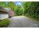 The gravel driveway leads to the house, and a storage shed can be seen in the background at 7725 Whitmire Ln, Mint Hill, NC 28227
