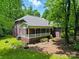 Brick house with a porch and lush green lawn at 7725 Whitmire Ln, Mint Hill, NC 28227
